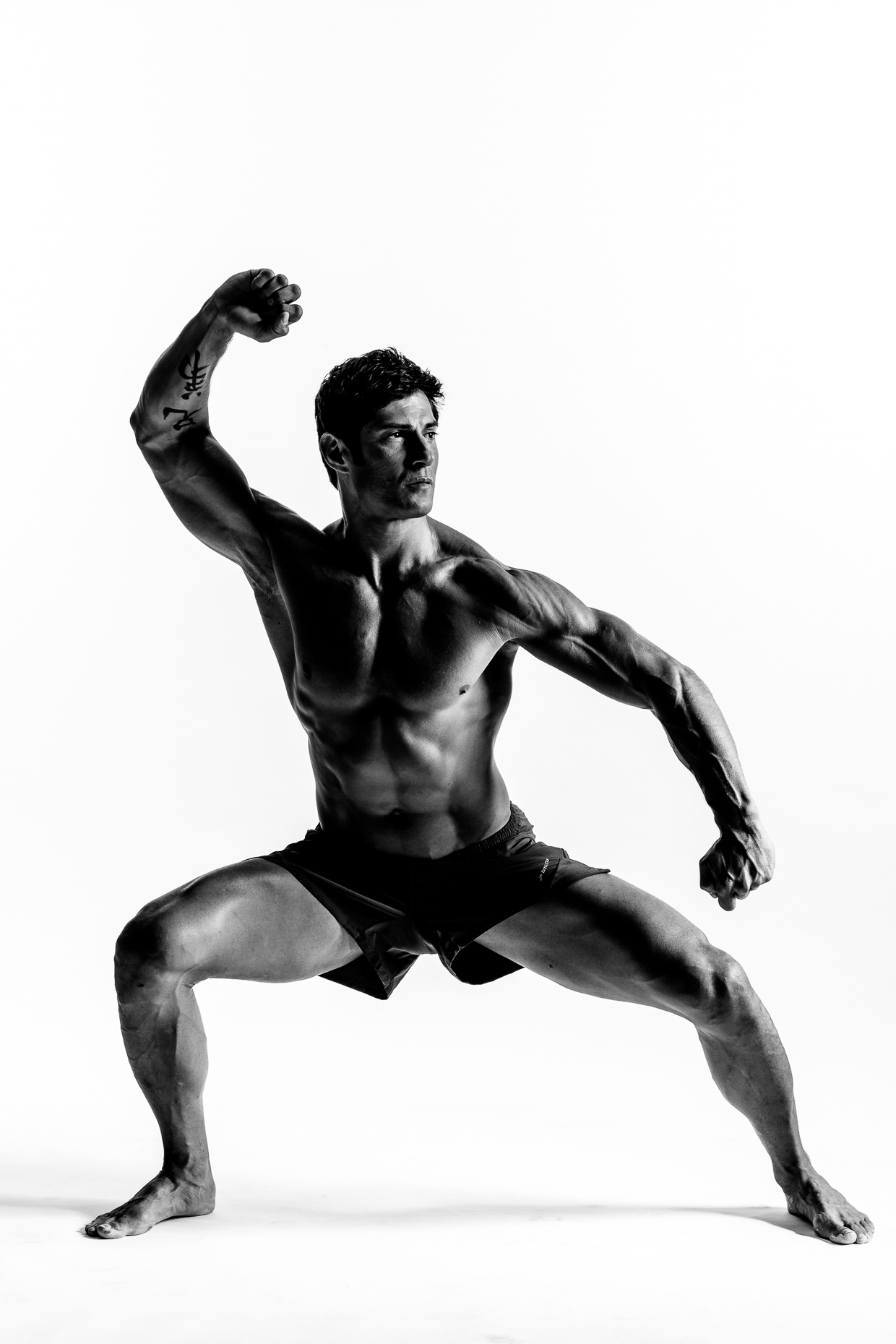 B&W on white background of Rudy Reyes martial arts instructor in warrior pose by andy batt