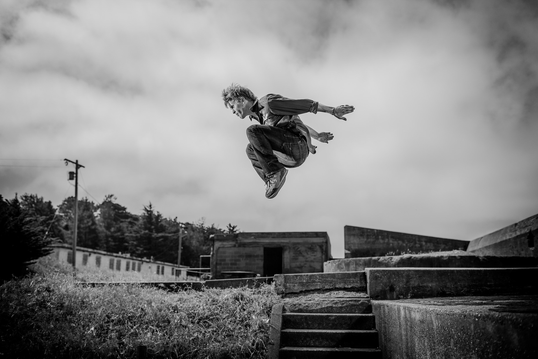 parkour freerunner athlete Brian Orosco flys between buildings at the Presidio army bunkers by andy batt