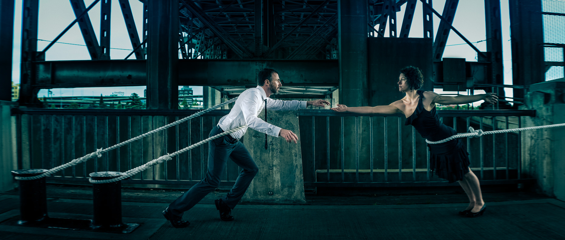 In this scene, Modern dancers Noel Plemons and Rachael Lembo practice social distance in this award-winning image under Morrison Bridge. The dancers reach towards each other, but are held back by ropes by Andy Batt