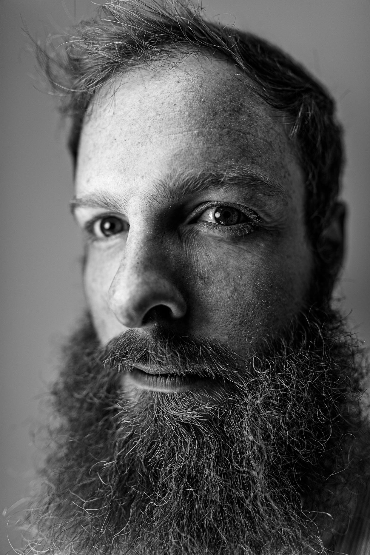 Tight B&W editorial portrait of photographer Cameron Browne. Photo by Andy Batt