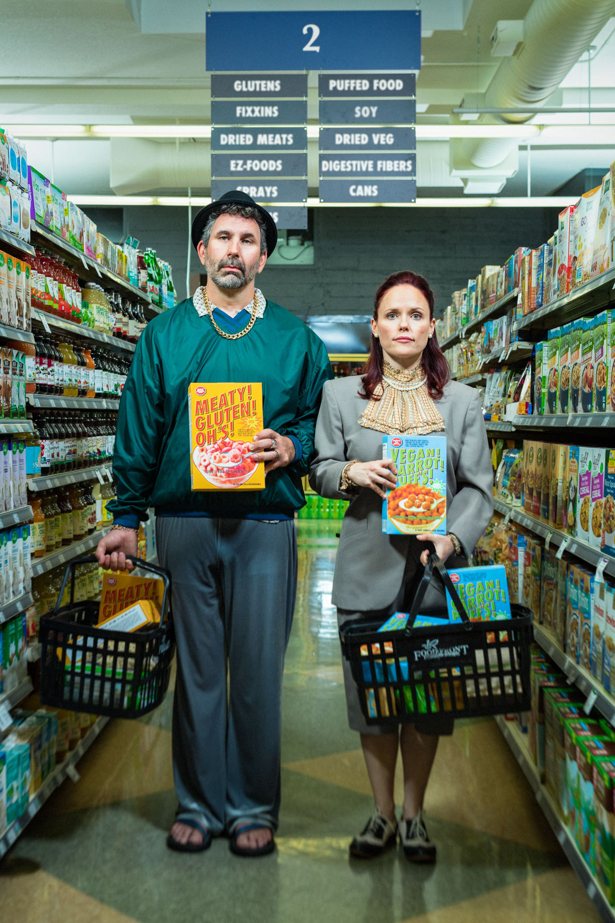 Drunk History actor Craig Cackowski and wife Carla Cackowski for Orange Tuxedo improv. Poster art of the couple standing in aisle 2 of a grocery store holding boxes of cereal. Photo by Andy Batt