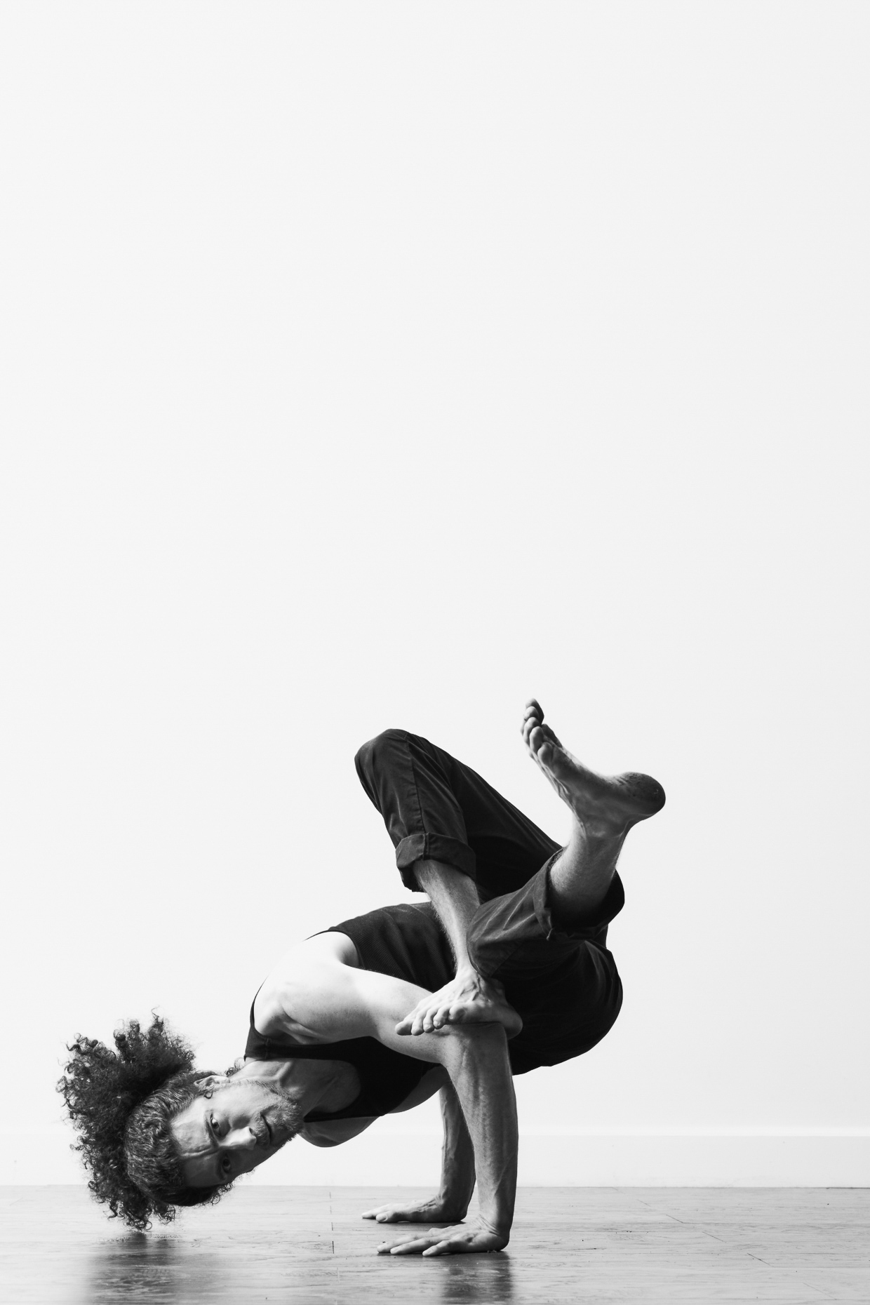 urban dancer Michael Galen break dances in a white studio by Andy Batt
