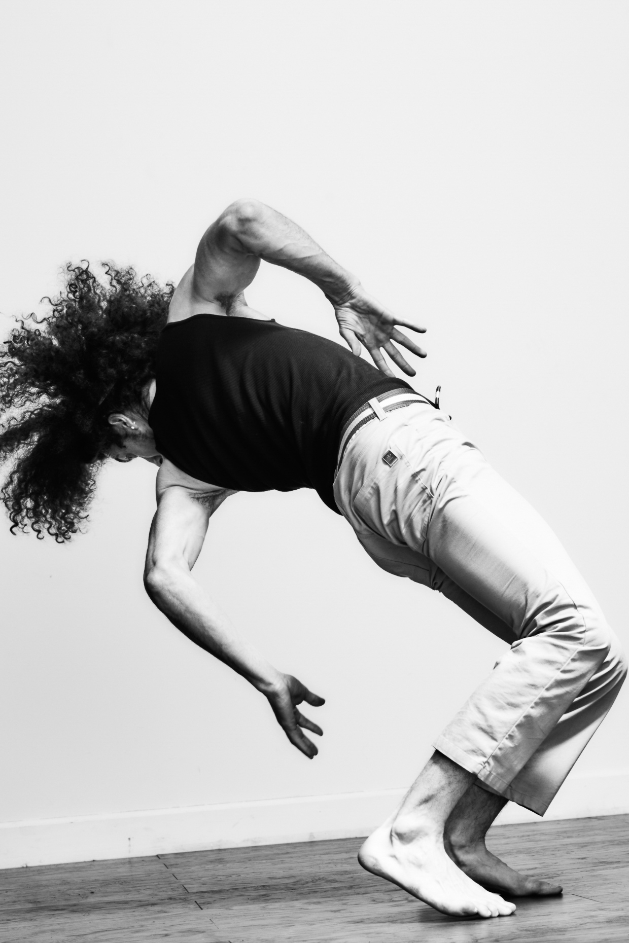 urban dancer Michael Galen break dances in a white studio by Andy Batt