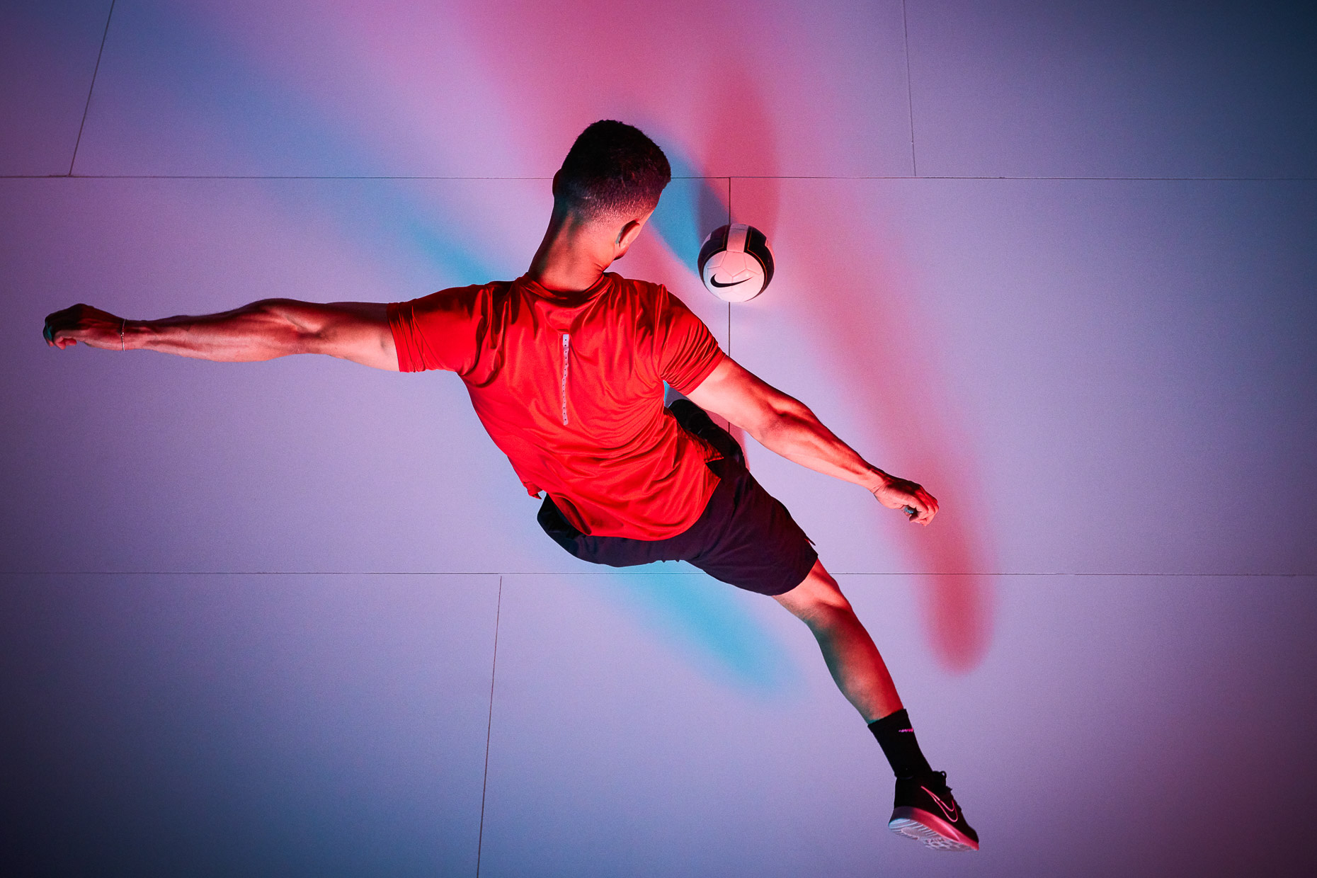 Nike Soccer futbol nike with Saif Alrikabi kicking the ball and shot from above with colorful blue and red gels by Andy Batt