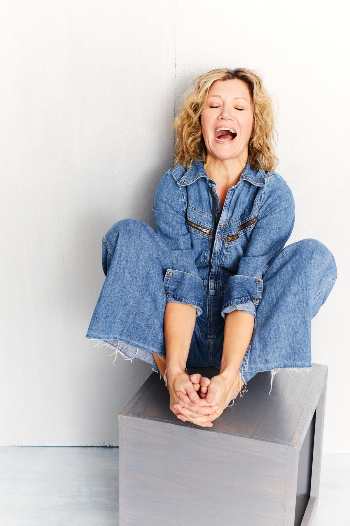 Actress portrait October Moore wearing denim overalls known for playing gold-digging Shannon in Baskets and acting mom Vicky Traux in Netflix