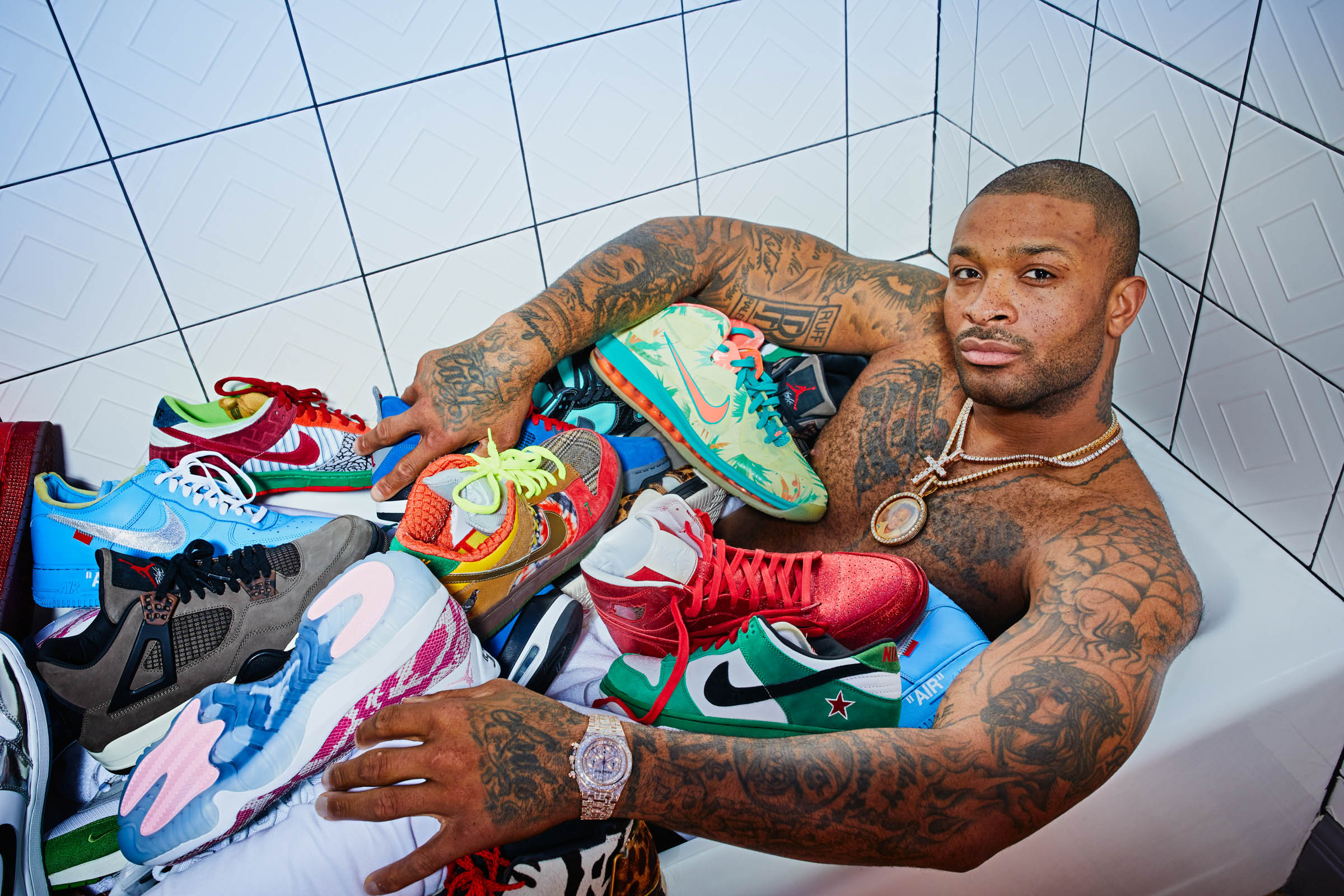 P.J. Tucker is the NBA’s sneaker king, and a forward on the Houston Rockets. Photographed in a  Monaco Hotel bathtub, covered in sneakers for Footwear News by Andy Batt.