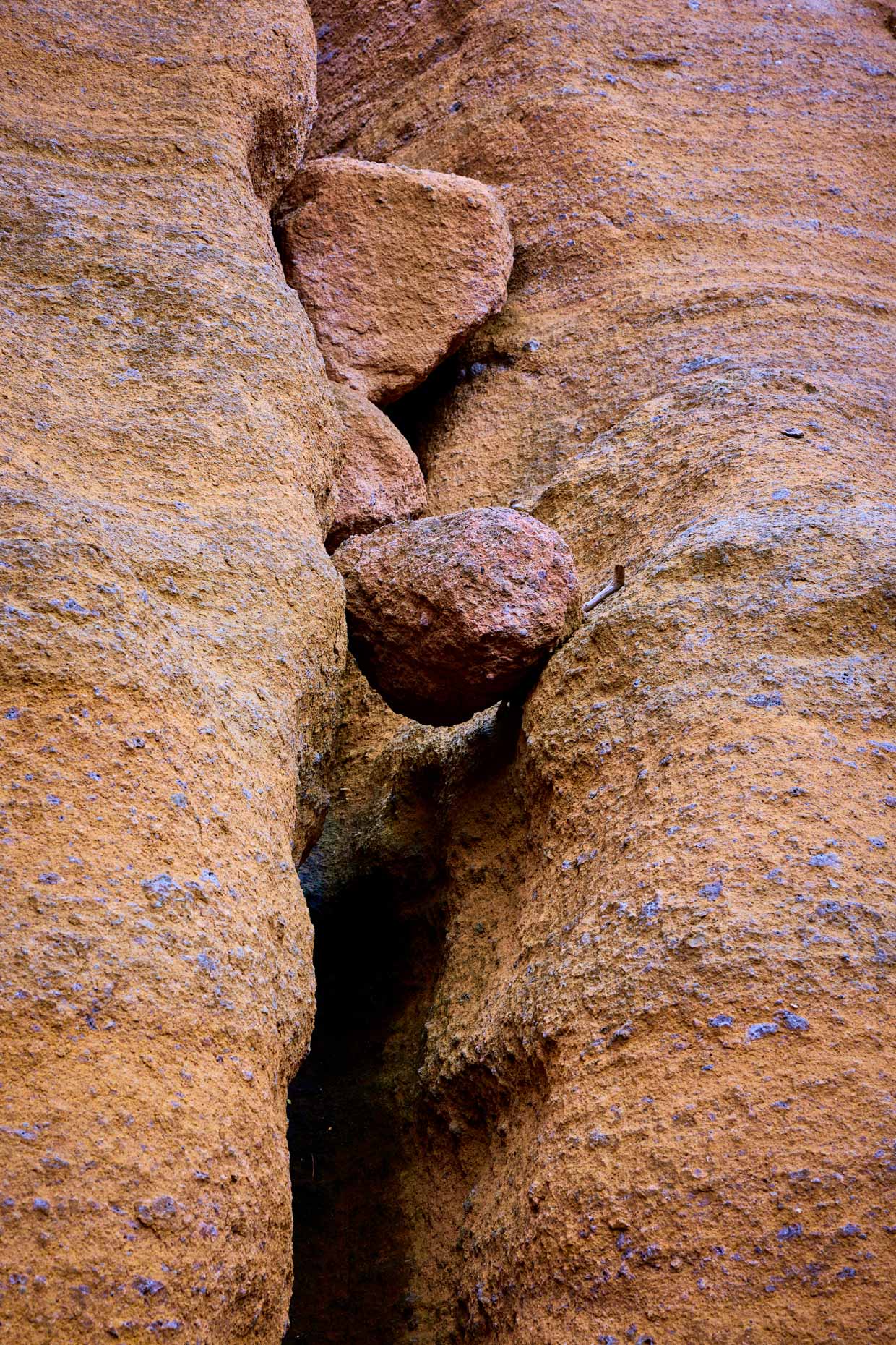 Red Mountain rock formation-single boulder balanced in crevass rock wall