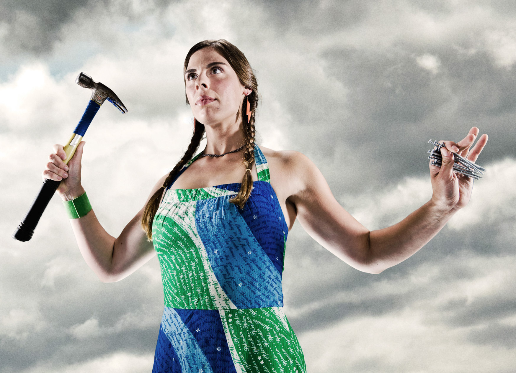 Woman holding hammer and nails. Propaganda poster art for Habitat for Humanity, featuring Audrey Rose Goldfarb. Photo by Andy Batt