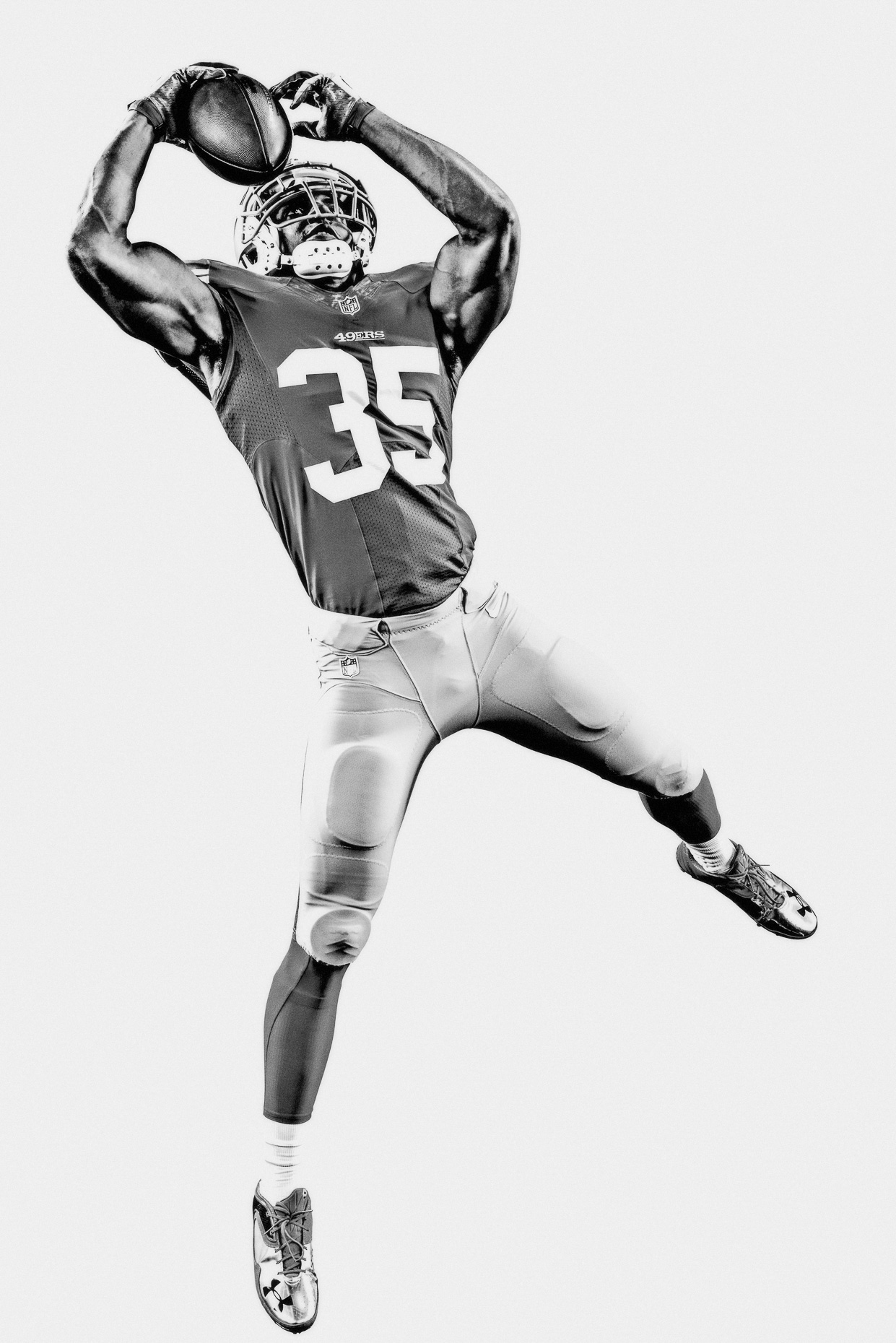 NFL Verizon Eric Reid catches football mid air San Francisco 49ers in a white studio by Andy Batt
